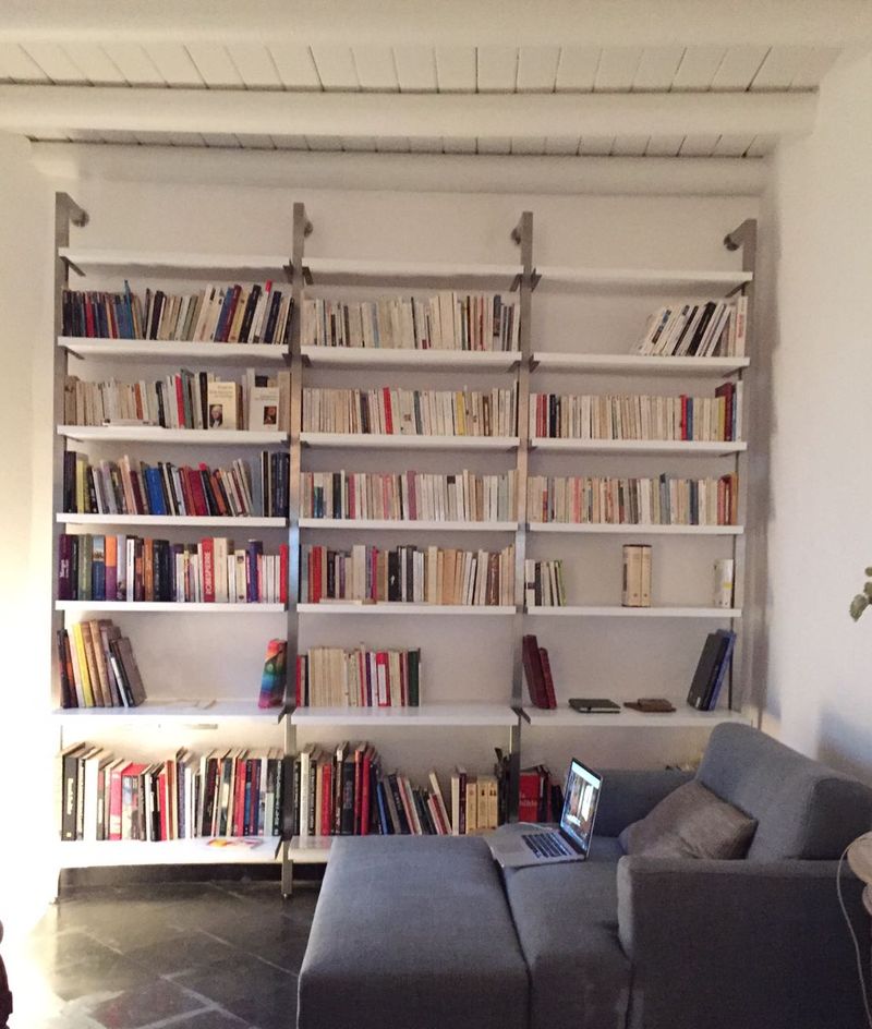 Libreria con estructura de acero inoxidable y baldas lacadas en blanco